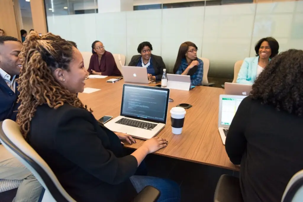 pexels photo 1181370 A diverse group of professionals working together in a modern conference room with laptops.