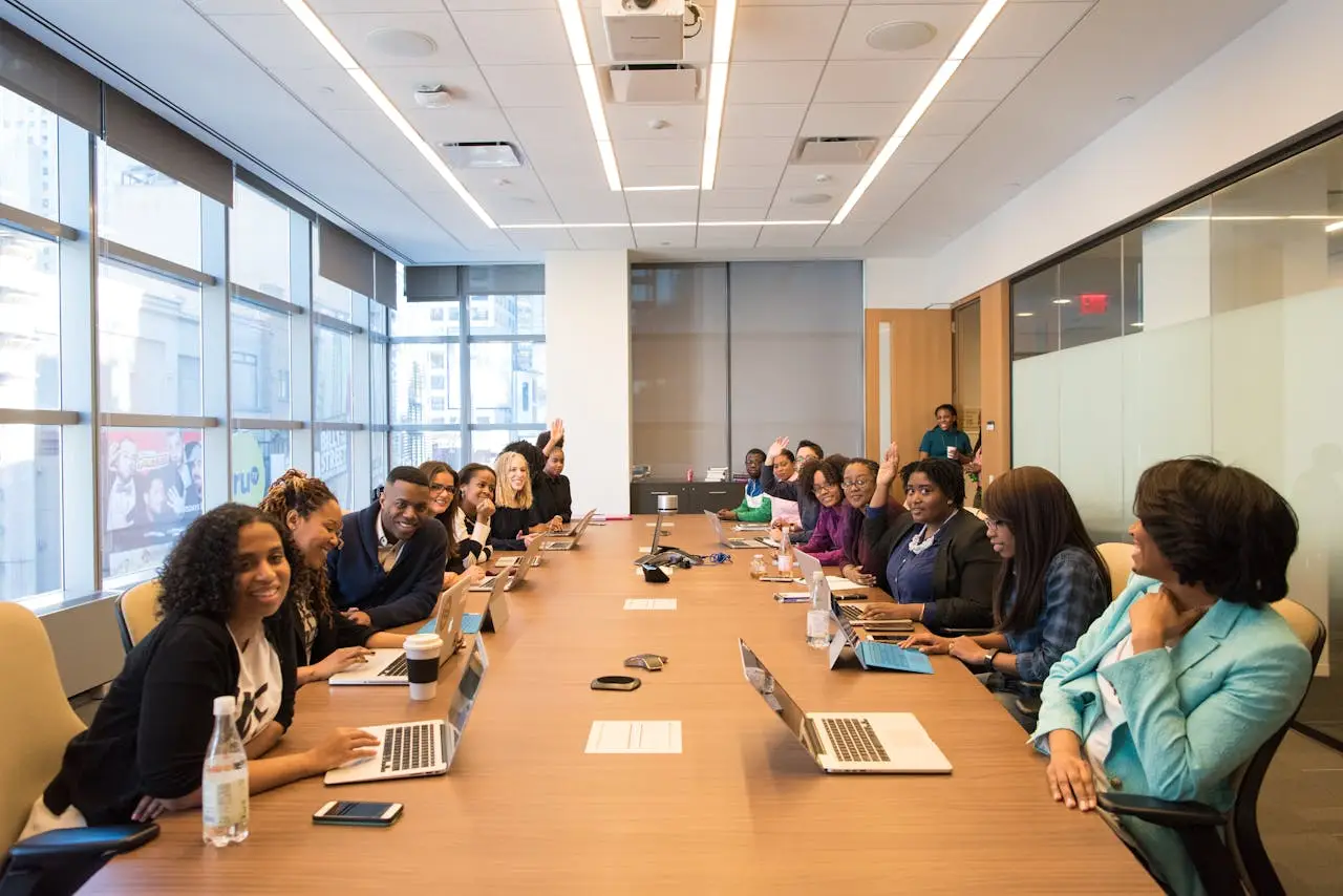 about-05 A diverse group of professionals engaging in a productive meeting around a conference table.
