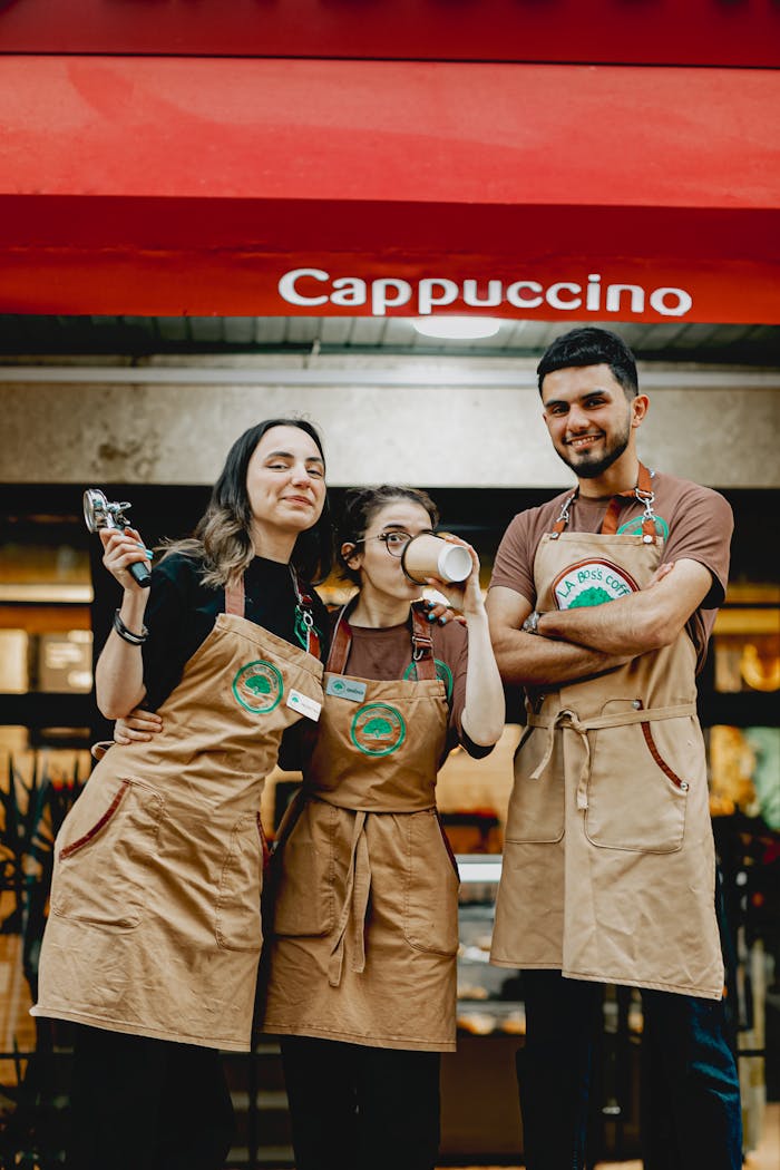 Mastering the First Impression: Your intriguing post title goes here Friendly baristas in aprons posing happily outside a café in Baku, Azerbaijan.