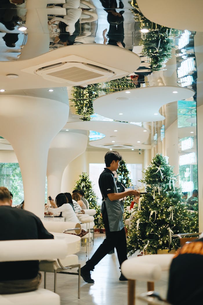 The Art of Drawing Readers In: Your attractive post title goes here Modern cafe interior during Christmas with festive decorations and customers dining.