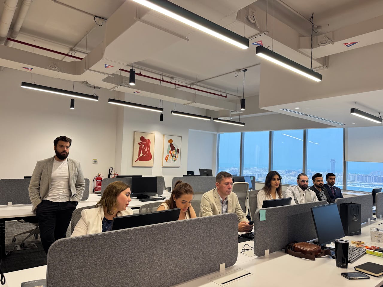 Professionals working in a modern office setting, collaborating and discussing business topics.