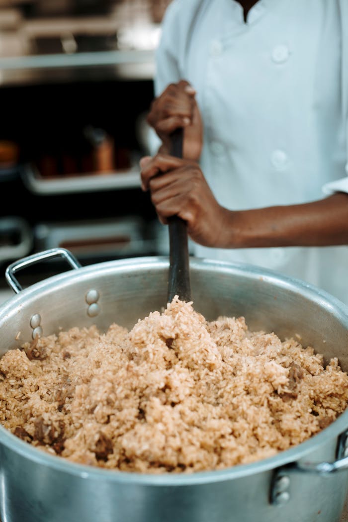 Crafting Captivating Headlines: Your awesome post title goes here Chef stirs a pot of freshly cooked rice in a professional kitchen setting.