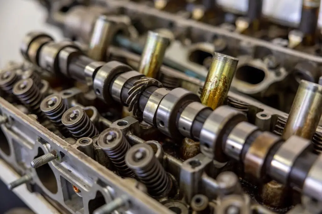 Training & Courses Detailed view of camshaft inside an engine block illustrating mechanical engineering.