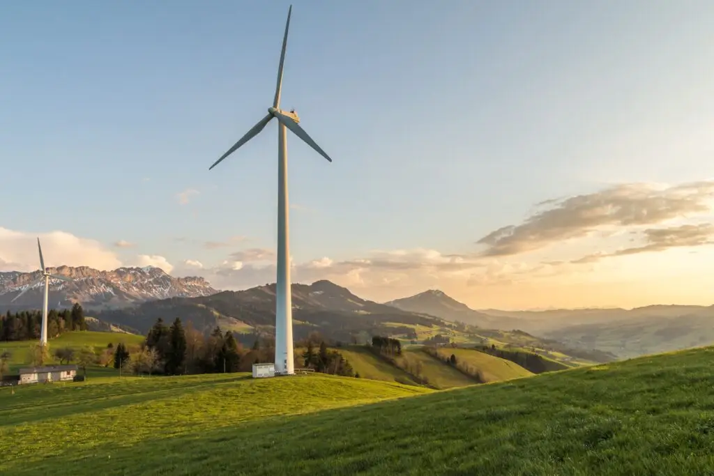 Training & Courses Peaceful countryside with wind turbines during sunset, showcasing sustainable energy.