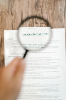 pexels photo 7821573 7821573 Magnifying glass focusing on 'Terms and Conditions' in a document. Ideal for business and legal themes.