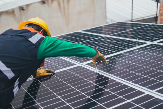 Renewable Energy Technician Programme- (FULL DETAILS) Technician installing solar panels on a rooftop for sustainable energy solutions.